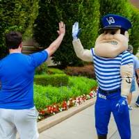 Person high-fiving Louie the Laker